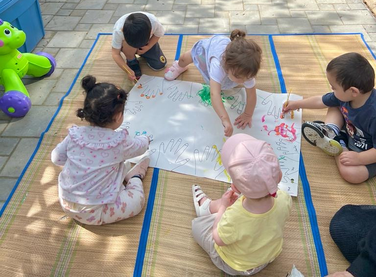 kids colouring on outdoor mat