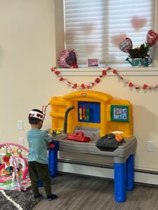 kid playing at toy bench